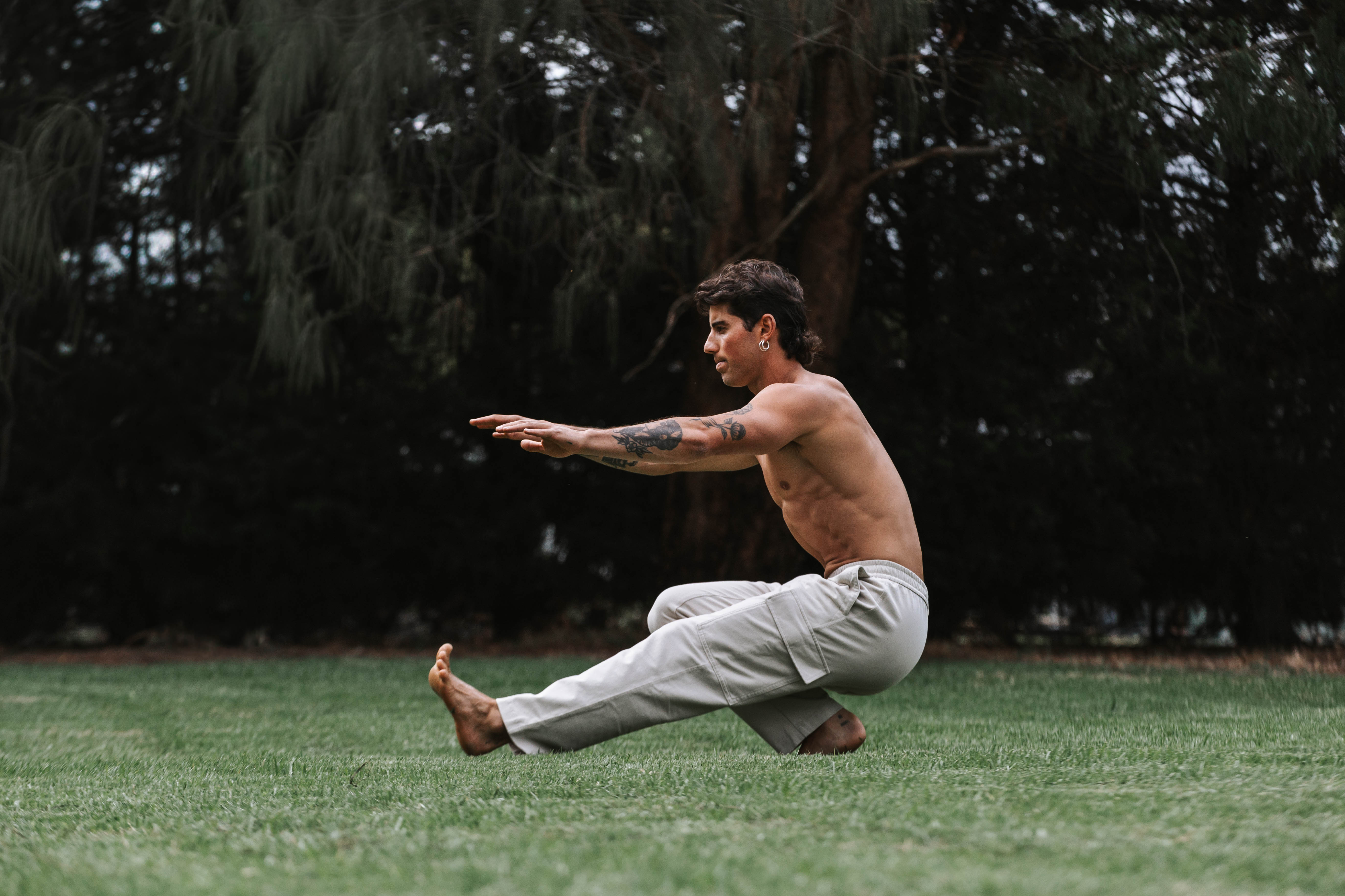 Tristan in a seated balance position on the grass